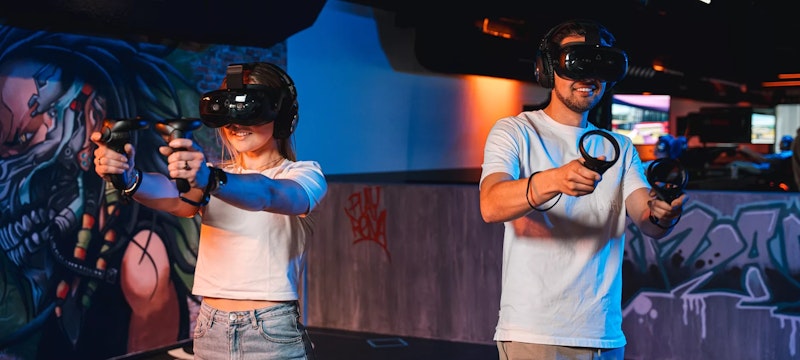 A couple immersed in an exciting VR game at Playrena Roosendaal, experiencing an action-packed and immersive virtual reality adventure together.