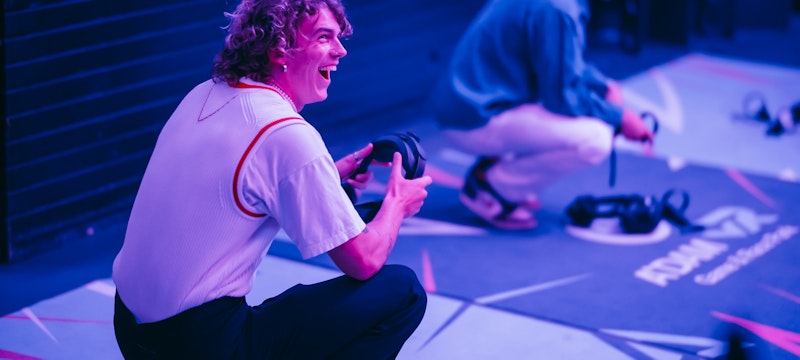 Someone laughing while enjoying the immersive VR experience at A'DAM VR Game & Race Park, located in the iconic A'DAM Tower in Amsterdam. A thrilling and fun-filled virtual reality adventure.