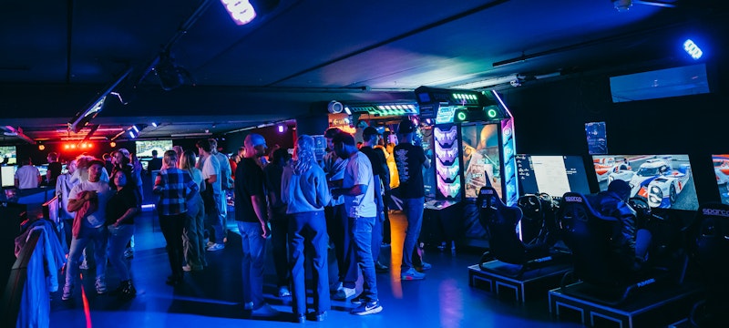 View of the LBE park at A'DAM VR Game & Race Park, filled with excited people enjoying various immersive virtual reality experiences at A'DAM Tower in Amsterdam.