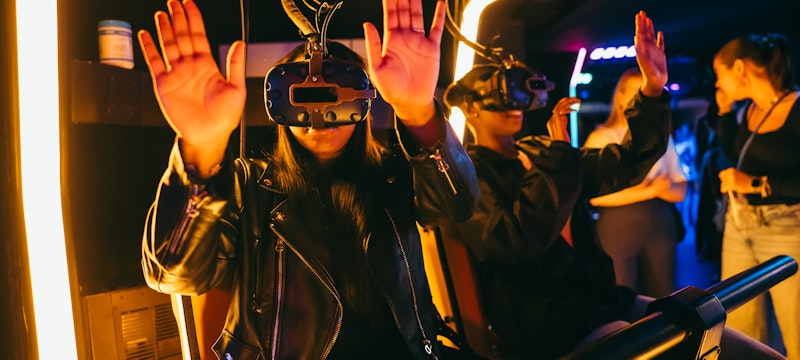 Group of people enjoying the Triotech Storm VR experience at A'DAM VR Game & Race Park, located in A'DAM Tower, Amsterdam. A thrilling, immersive virtual reality ride featuring action-packed gameplay.